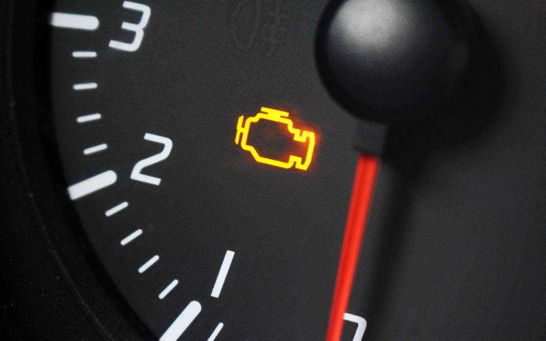Amber check engine light glowing on a gauge, the same warning a Ford shows